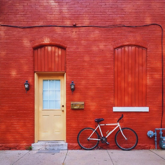 Red house with peach door and bike